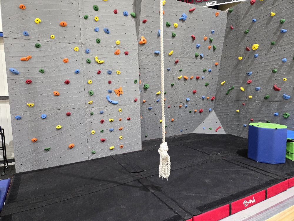 Artificial climbing wall with colorful hand hold and different challenging angles. Includes long climbing rope with plenty of crash pads for safety. 