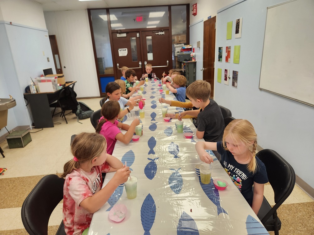 Kids at the table doing afterschool activities.