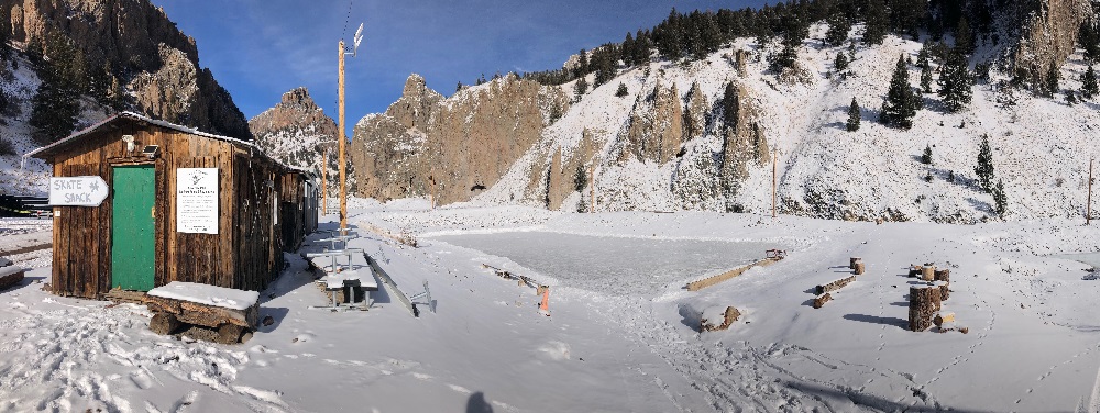 Wintertime photo of the Silver Ice Hockey Ponds, with skate shack and amazing cliffs for a backdrop.